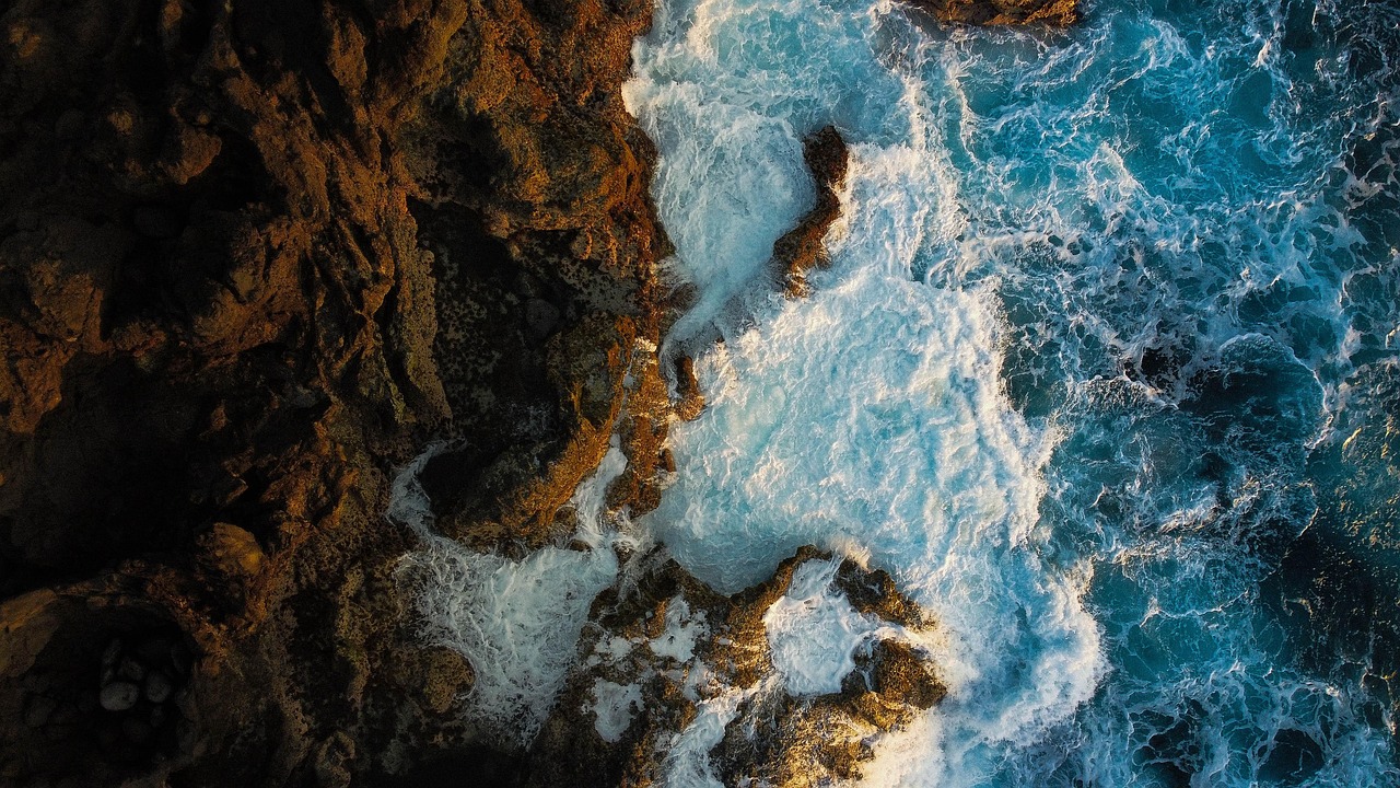 deep blue Atlantic ocean meeting volcanic cliffs