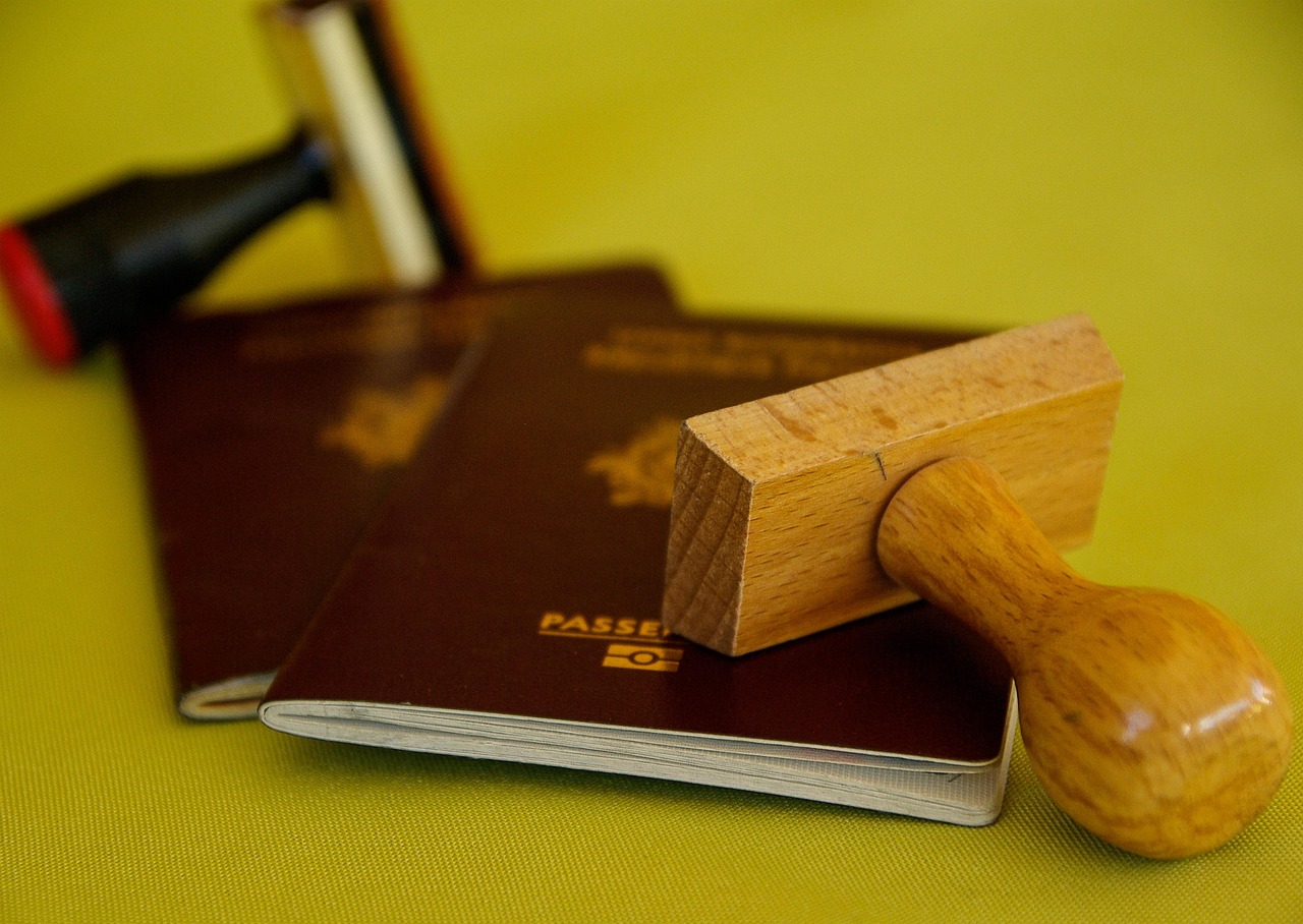 Border officer stamps passport of American visitor after ETIAS approval for entry into Europe