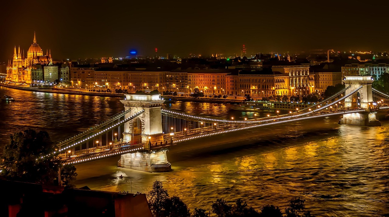 Budapest Danube river at sunset with illuminated bridges and boats