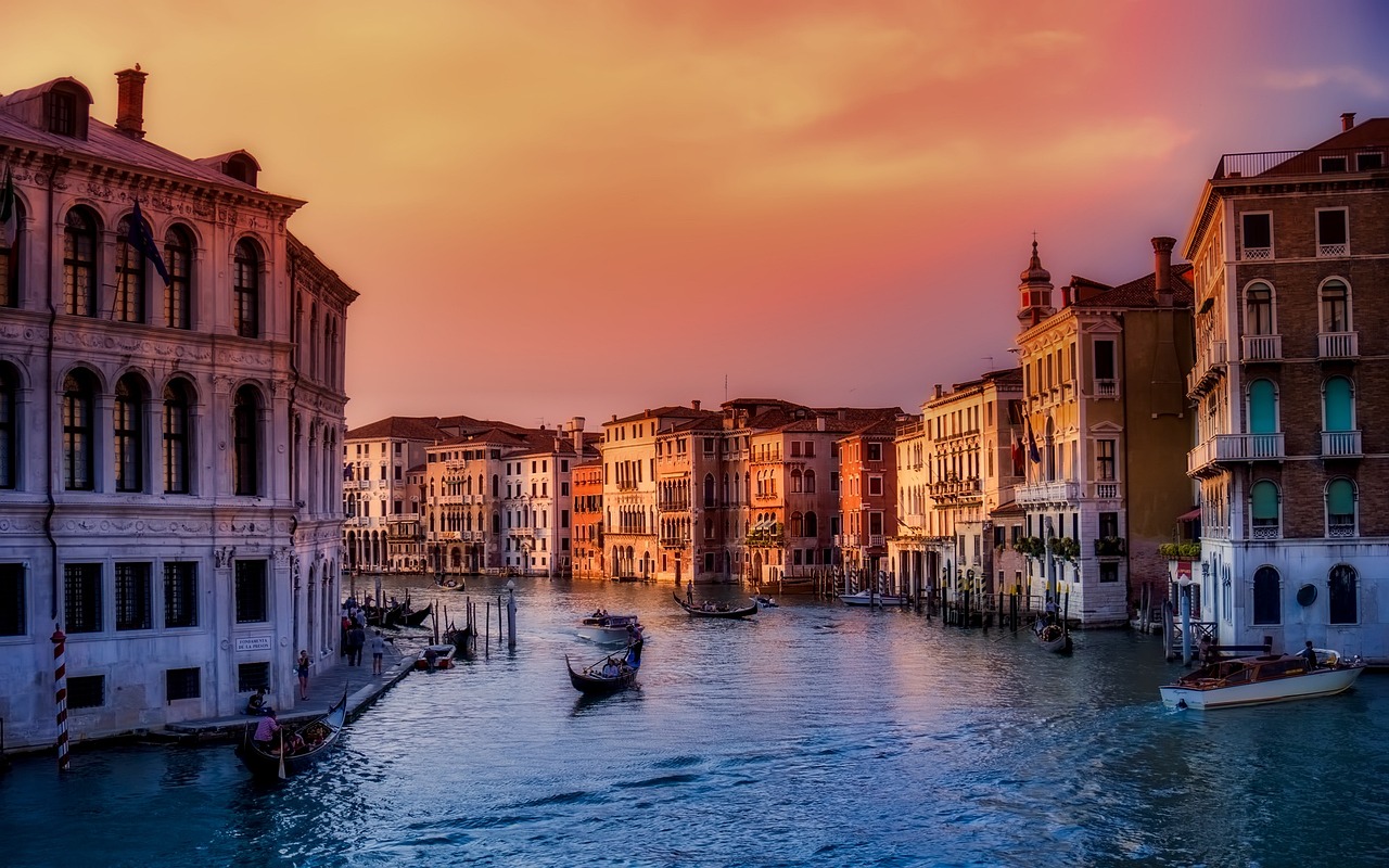 Quiet Venice canals with gondolas passing historic buildings