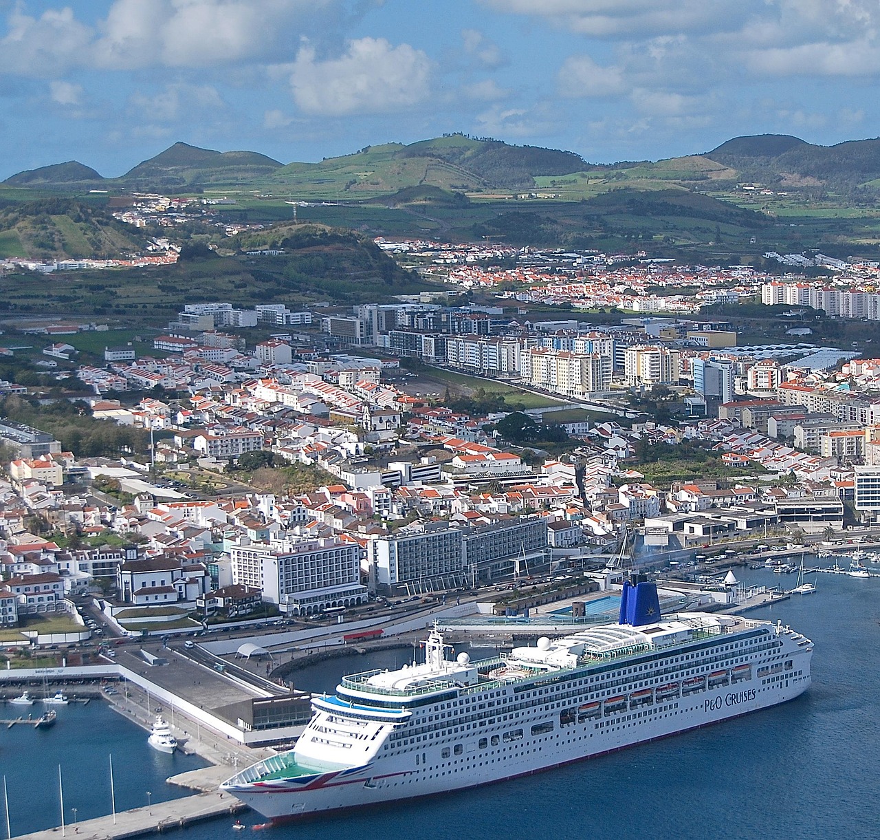 Things to do in Ponta Delgada features the iconic lighthouse viewed from the harbor at sunset