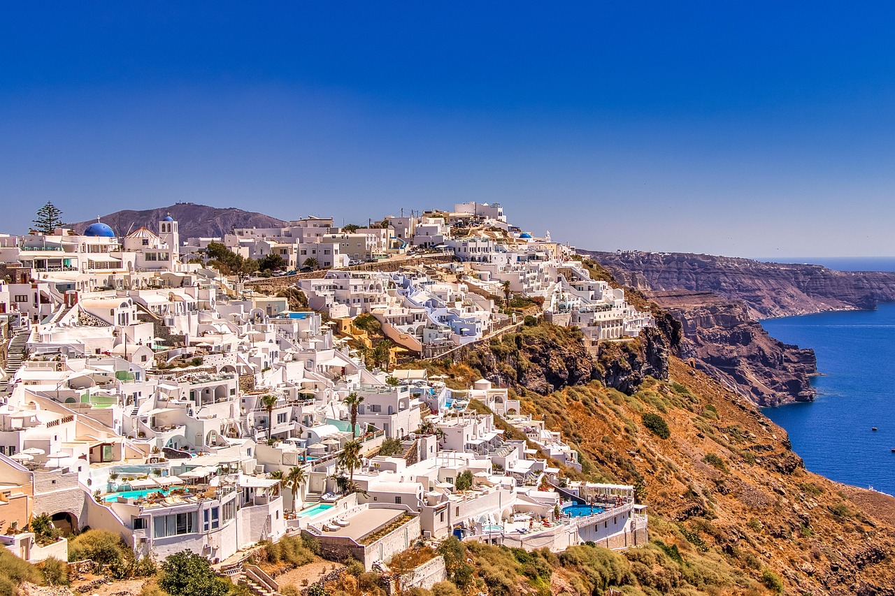 Santorini beach with white cliffs and clear water